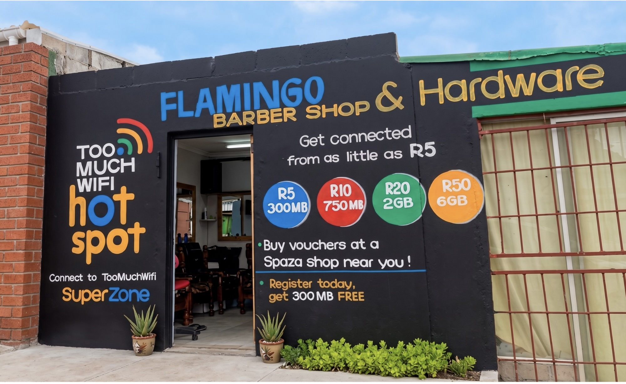 A barber shop and hardware store in South Africa advertising a pay-as-you-go wifi hotspot, with voucher prices from R5 for 300MB